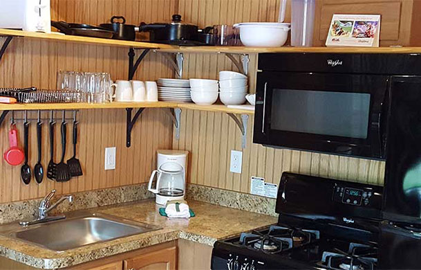 Deluxe cabin full kitchen with appliances at Adventure Bound Southwoods